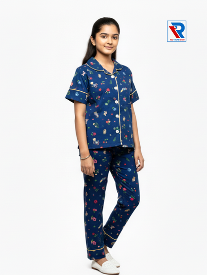 Girls night suit set, ages 7–12, charming dark blue top and pyjama pants, folded‑leg view – RioTrend kids sleepwear showcasing a casual, relaxed pose.