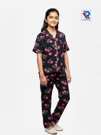Girls night suit set, ages 7–12, elegant black top and pyjama pants, folded‑leg view – RioTrend kids sleepwear showcasing a casual, relaxed pose.