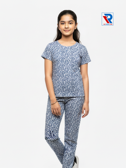 Girls pyjama set in blue color, ages 1–12, folded‑leg view – RioTrend kids sleepwear showcasing a casual, relaxed pose.