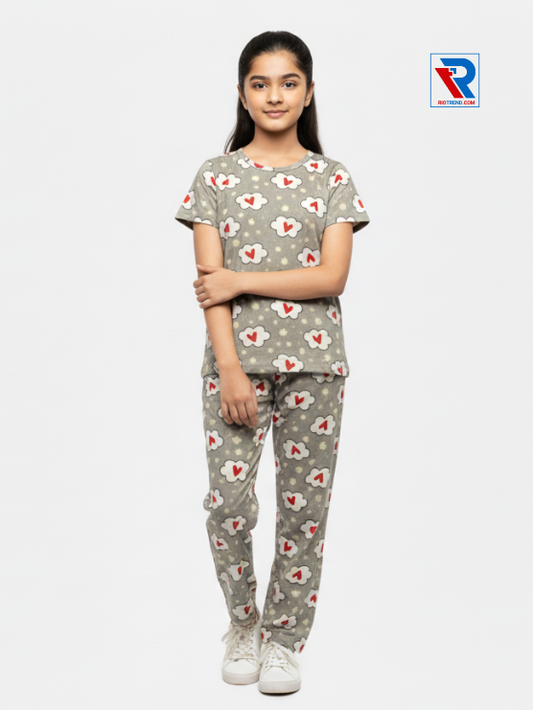 Girls pyjama set in tan color, ages 1–12, folded‑leg and folded‑arms view – RioTrend kids sleepwear highlighting a casual, confident pose.