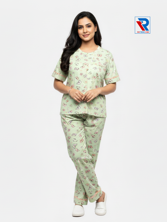 Women’s pyjama set, sizes M–XL, light green top and pyjama pants, folded‑leg arms view – RioTrend sleepwear showcasing a casual, relaxed pose.